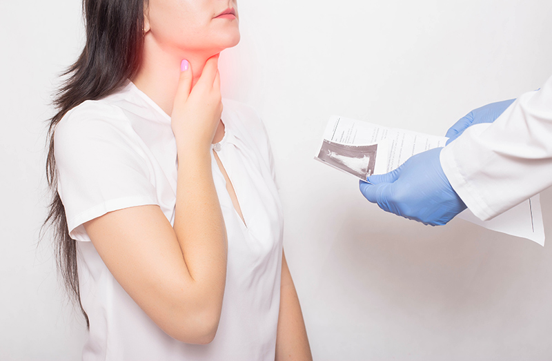 A woman viewing the results of her neck examination